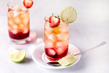 Glasses of Cold Citrus and Strawberry Ice Tea Decorated with Slice of Lemon and Strawberry Healthy Summer Drink Horizontal