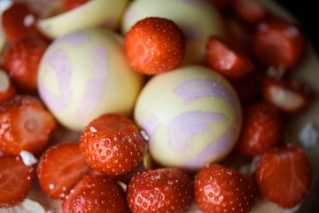 Cake with strawberry and chocolate spheres. Closeup decor.