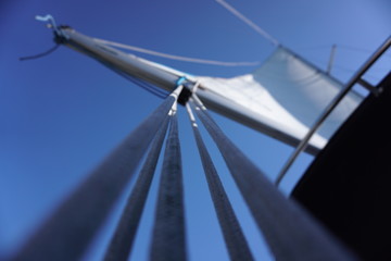 Beautiful blue sky with mainsheet and sail from sailing yacht on summer day.