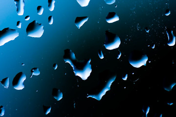 Blue drops of water on a black background