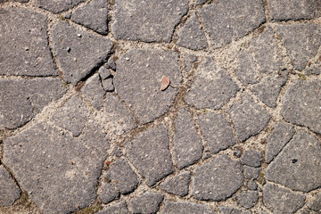 Fototapeta premium The texture of the broken road. Old building blocks. Background for screensaver monitor