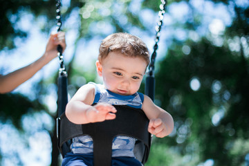 baby boy on swing in a playground in hilton head island 