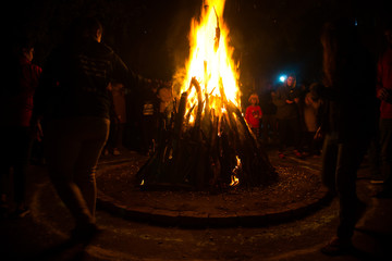 Giant bon fire lit for the festival of Lohri surrounded by people