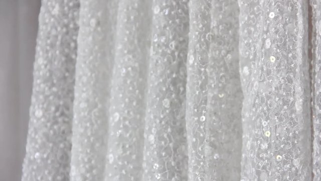 close-up long skirt of stylish wedding dress with shiny rhinestones. wedding concept, texture background, free space