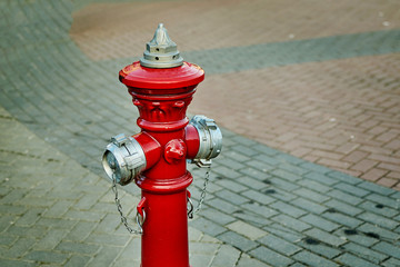 Fototapeta na wymiar Red fire hydrant on the street.