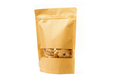 brown craft food packaging in paper, plain doypack standup bag filled with biscuits with window and...