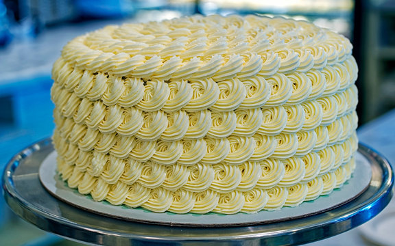 Round creamy tart cake on the bakery storefront reflex