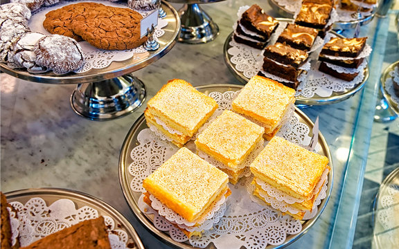 Assorted cookies and cakes on the bakery storefront reflex