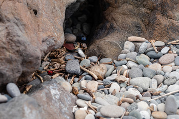 garbage on the beach among the rocks. stop plastic