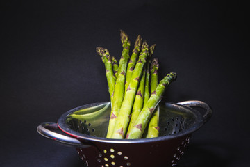 raw green asparagus on background
