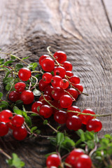Fresh berry, red currant, green thyme on an old wooden background. Rustic. Background image, copy space