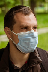 COVID-19 Pandemic Coronavirus Man in city street wearing face mask protective for spreading of Coronavirus Disease 2019. Portrait of man with face mask against SARS-CoV-2