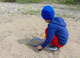 little boy playing on the beach