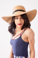 Lovely woman in a straw hat looking thoughtful