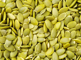 Macro background texture of green pumpkin seeds