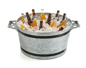 Bucket with ice and bottled drinks, party buzz basket, isolated, side view. Bottles of cooler drinks with ice.
