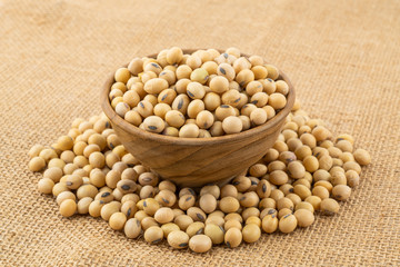 Soy beans in a wooden bowl on sack cloth. Soybean is a kind of legume native to east asia.