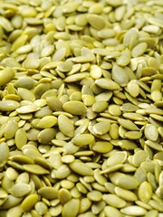 Macro background texture of green pumpkin seeds