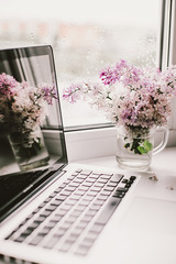 self-isolation workplace, computer and beautiful flowers - 350936009