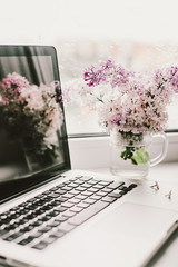 self-isolation workplace, computer and beautiful flowers - 350936018