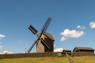 Fototapeta na wymiar Traditional windmill on field
