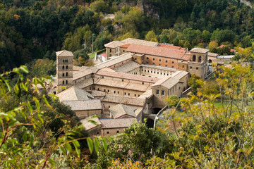 View of Saint Scholastica medieval monastery surrounded, by trees in Subiaco. Founded by Benedict...