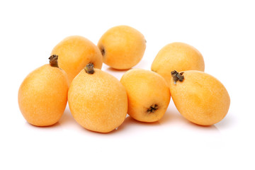 Close up view of some loquat fruit isolated on a white background