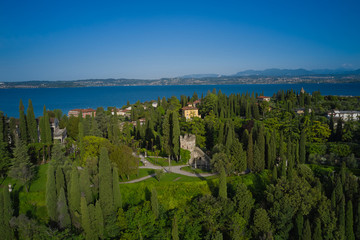 Fototapeta na wymiar The historical part of the location in the park is the island of Sirmione Lake Garda, Italy. Aerial view