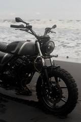 Fototapeta na wymiar black motorcycle on the background of the ocean