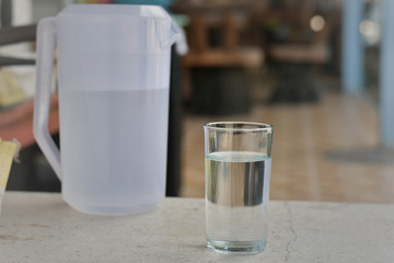 glass water on the table in the cafe during the holidays