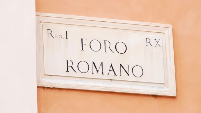 Close up of Foro Romano adress sign in Rome city, Italy. Forum Romanum white marble plate on building wall