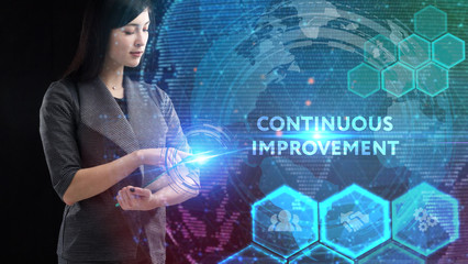 Business, Technology, Internet and network concept. Young businessman working on a virtual screen of the future and sees the inscription: Continuous improvement