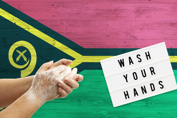 Vanuatu flag background on wooden surface. Minimal wash your hands board with minimal international...