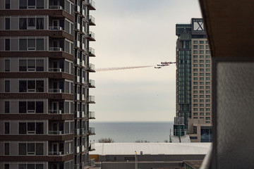 Planes flying between buildings