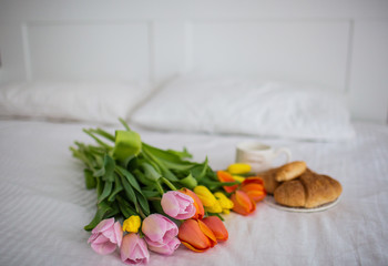 breakfast on a tray in a white bedroom