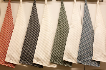 texture of multi-colored kitchen towels hanging on a hanger, closeup.