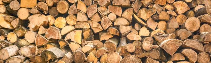 panorama. pattern of firewood. light wooden background