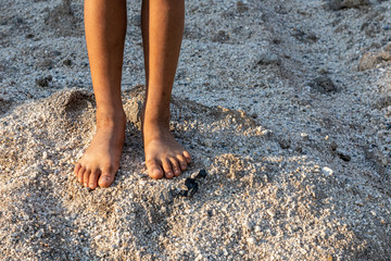 The feet of the poor Asian children stood on the sand pile.