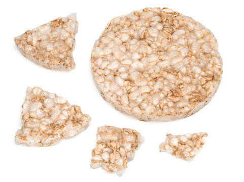Puffed rice bread and its pieces isolated on white background, diet crispy round multigrain rice waffles