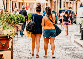 Girls in street of Cefalu town Sicily reflex