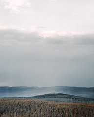 Fog over forest and mountains in background Sweden, Dalarna