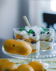 Homemade tiramisu with lemons served on table. Top view of delicious dessert in glass cups.