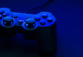 Black gamepad with blue backlight and beautiful shadows