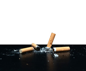 Burning cigarette left in ashtray on white background