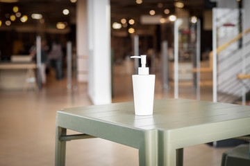 A bottle of hydroalcoholic gel at the entrance of a shop during the coronavirus pandemic.