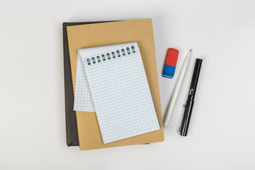 stack of colorful notebooks with pen isolated on white background