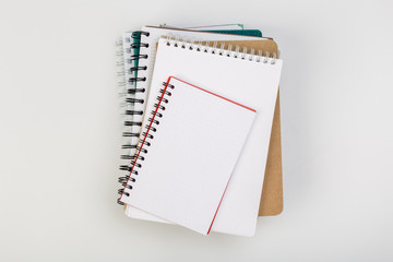 stack of colorful notebooks with pen isolated on white background