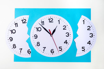 Two clock faces on a blue-white background one whole, the other is divided into two parts