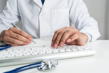 Doctor typing on wireless computer keyboard