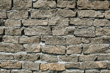 The texture of the old wall made of stone imitating brick.